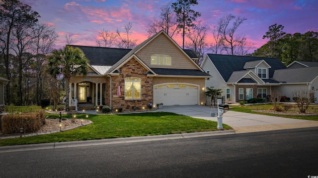 view of front of property with concrete driveway, an attached garage, a front lawn, and stone siding