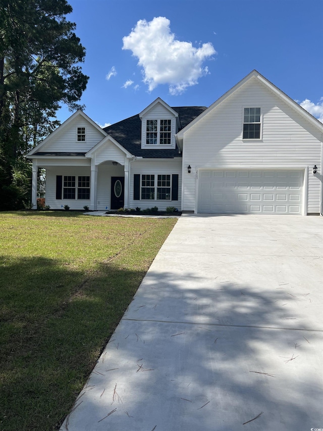 view of front facade featuring roof with shingles, driveway, and a front lawn