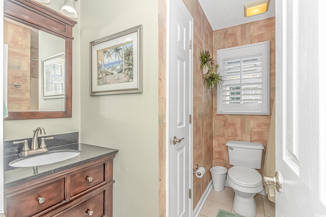 bathroom featuring vanity, tile patterned floors, and toilet