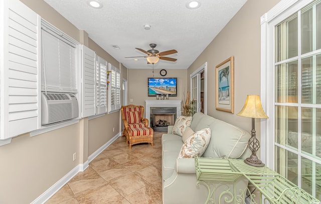 interior space featuring visible vents, cooling unit, a fireplace, and a ceiling fan