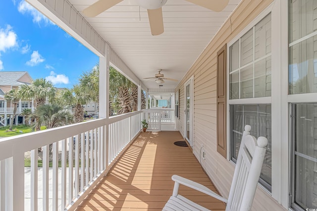 wooden deck with a ceiling fan and covered porch