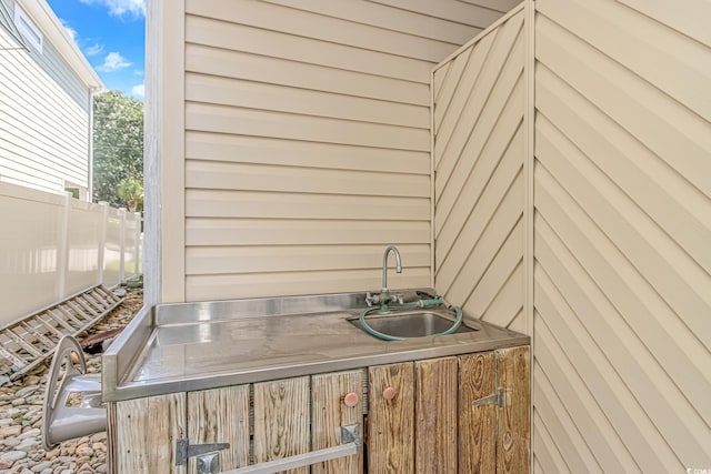 view of patio featuring a sink and fence