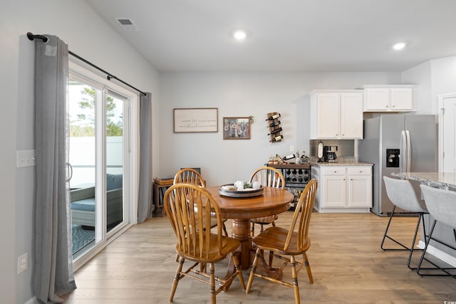 dining area featuring light wood-type flooring and recessed lighting