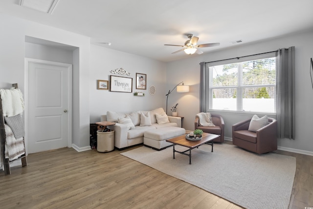 living area with wood finished floors, ceiling fan, and baseboards