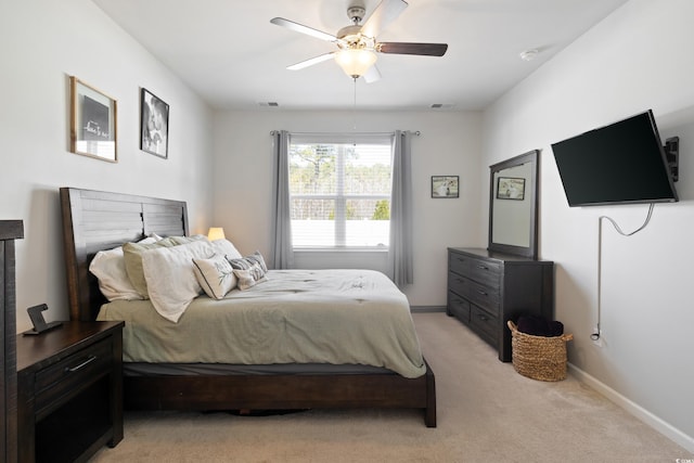 bedroom with light colored carpet, baseboards, and ceiling fan