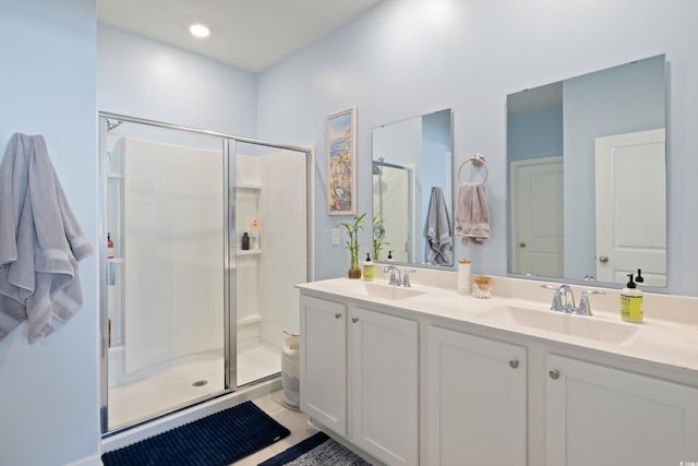 full bath featuring a shower stall and double vanity