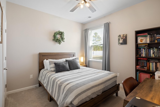 bedroom with light carpet, baseboards, and a ceiling fan