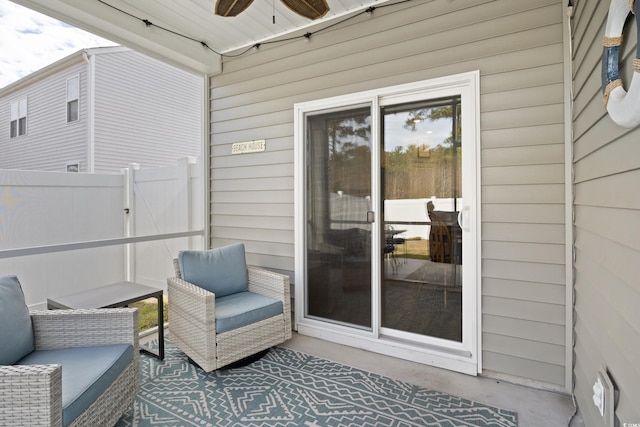 view of patio with ceiling fan and fence
