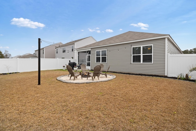 back of property with an outdoor fire pit and a patio area