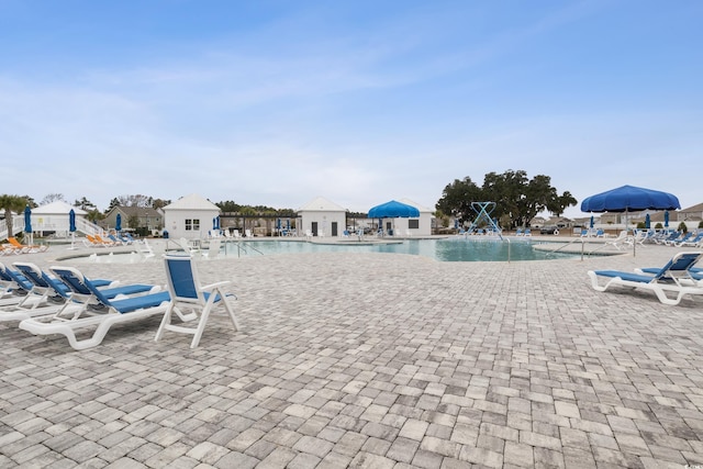 community pool featuring a patio area and fence