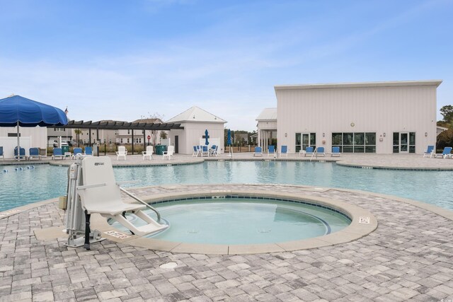 community pool featuring a patio, a pergola, and a hot tub