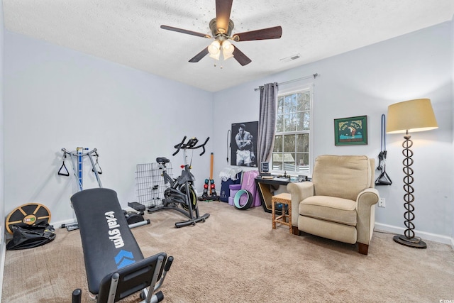 workout area featuring visible vents, baseboards, a ceiling fan, a textured ceiling, and carpet floors