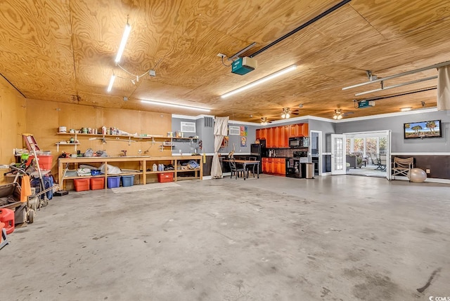 garage featuring a garage door opener and a workshop area