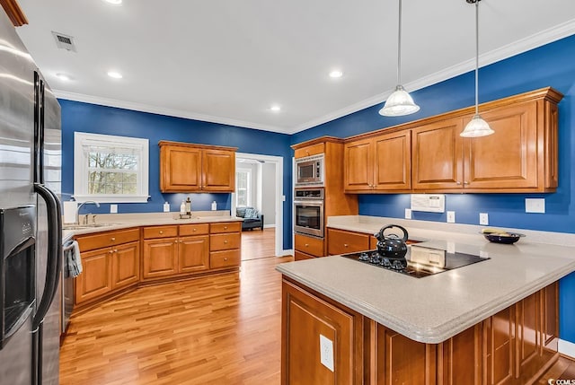kitchen with crown molding, appliances with stainless steel finishes, brown cabinetry, and light wood-style flooring