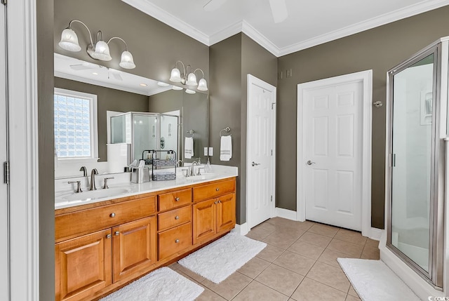 bathroom featuring a sink, ornamental molding, and a shower stall