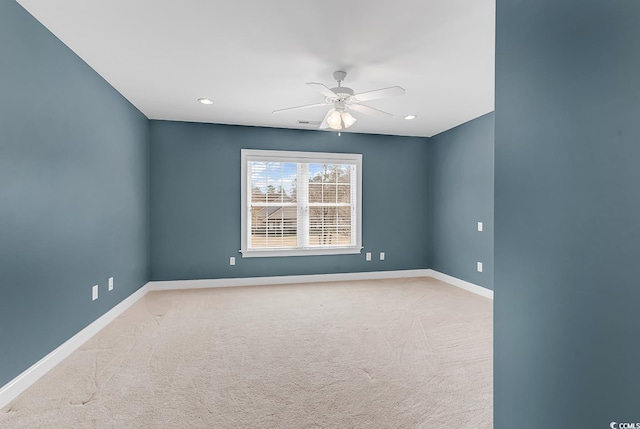 empty room with carpet flooring, recessed lighting, ceiling fan, and baseboards