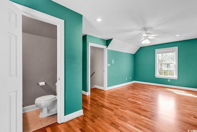 bonus room with vaulted ceiling, baseboards, a ceiling fan, and wood finished floors