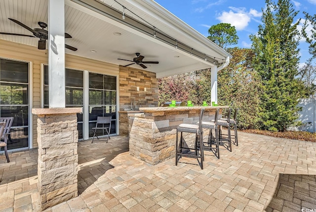 view of patio featuring ceiling fan and outdoor dry bar