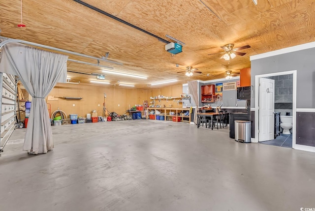 garage with a workshop area and a ceiling fan