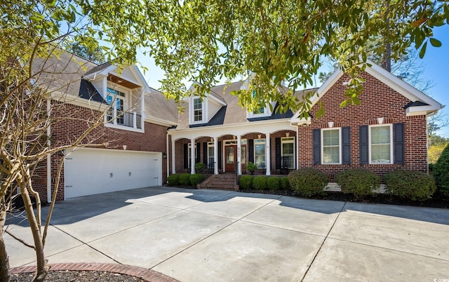 view of front of home with brick siding, an attached garage, and driveway