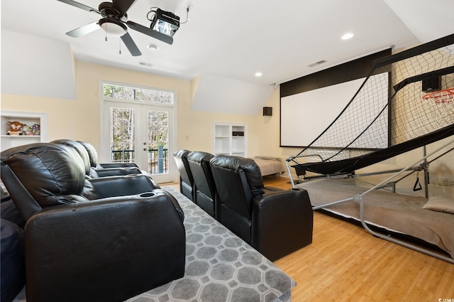 cinema room with visible vents, recessed lighting, french doors, wood finished floors, and a ceiling fan