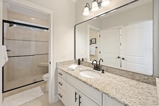 bathroom with tile patterned floors, toilet, a stall shower, crown molding, and vanity