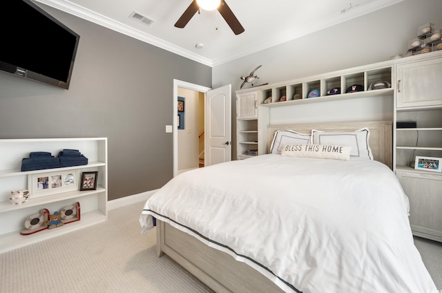 carpeted bedroom with visible vents, baseboards, crown molding, and ceiling fan