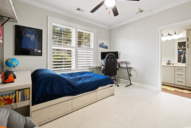 carpeted bedroom with a sink, visible vents, baseboards, and ornamental molding