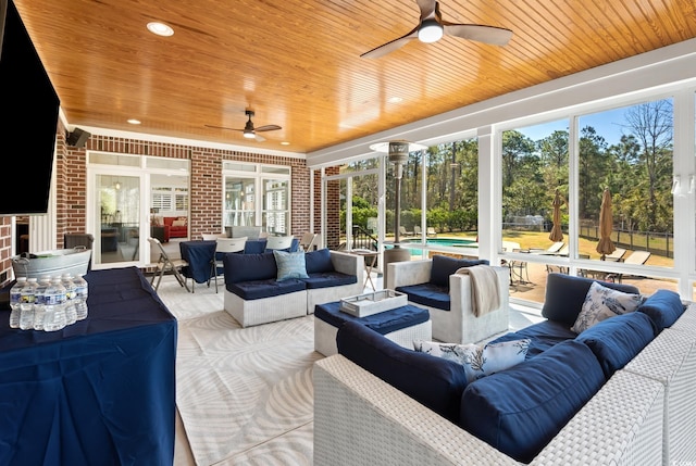 interior space with wood ceiling and a ceiling fan