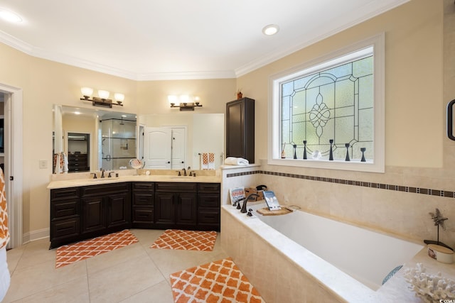 full bath with tile patterned floors, a garden tub, crown molding, and a sink