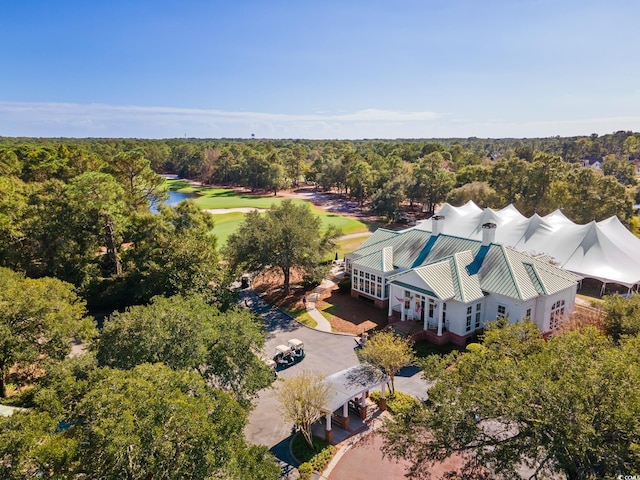 birds eye view of property featuring view of golf course and a wooded view