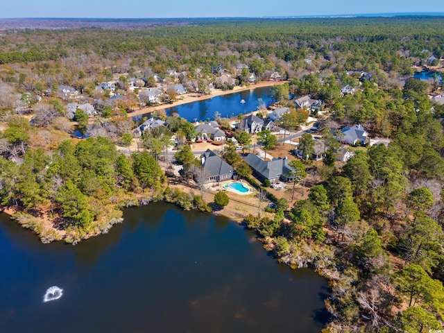 aerial view with a residential view, a view of trees, and a water view