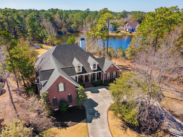 bird's eye view with a water view and a wooded view