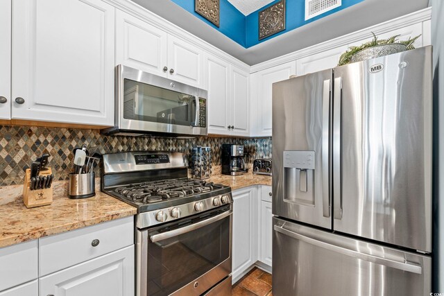 100 N Beach Blvd Unit 1608, North Myrtle Beach, SC 29582 - kitchen with appliances with stainless steel finishes, white cabinetry, tasteful backsplash, and light stone counters