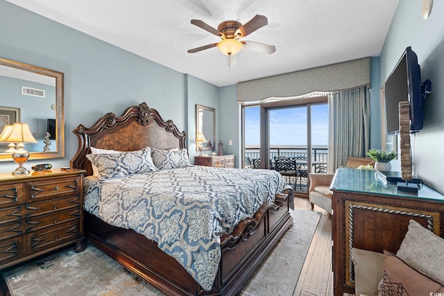 100 N Beach Blvd Unit 1608, North Myrtle Beach, SC 29582 - bedroom with access to exterior, a ceiling fan, and a textured ceiling