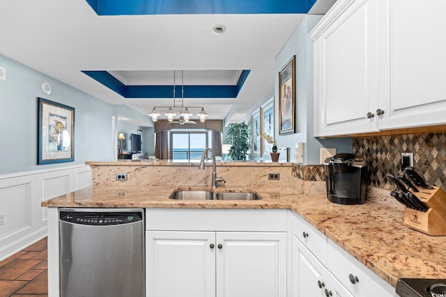 100 N Beach Blvd Unit 1608, North Myrtle Beach, SC 29582 - kitchen with dishwasher, a raised ceiling, decorative backsplash, a peninsula, and light stone counters