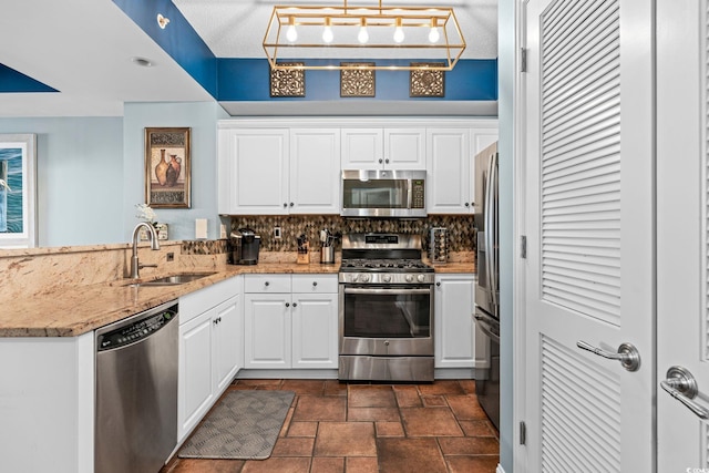 100 N Beach Blvd Unit 1608, North Myrtle Beach, SC 29582 - kitchen with stainless steel appliances, a peninsula, dark stone finish flooring, and white cabinets