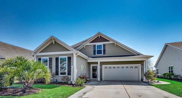 view of front of home with a garage, concrete driveway, and a front lawn