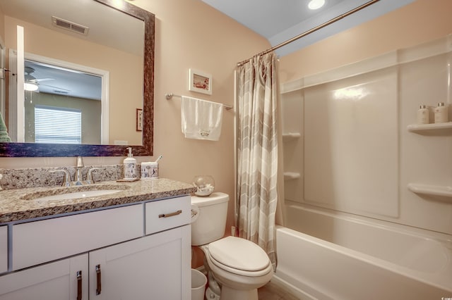 full bath featuring visible vents, shower / bath combo with shower curtain, toilet, ceiling fan, and vanity