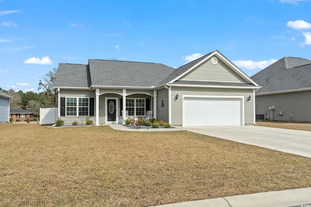 single story home with an attached garage, concrete driveway, a front lawn, and a shingled roof