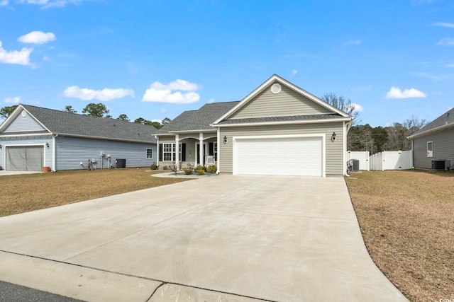 ranch-style house with driveway, an attached garage, central AC, and a gate