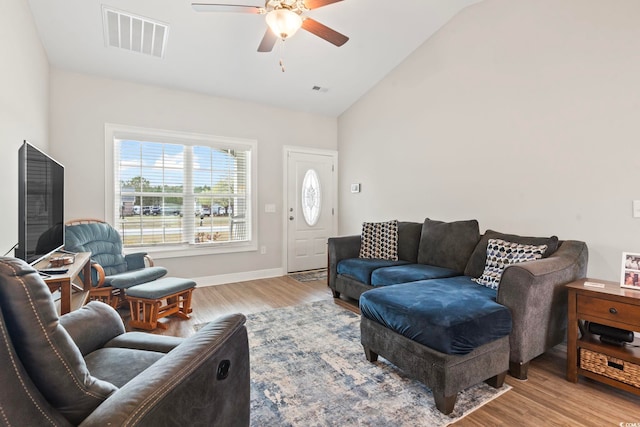 living room with visible vents, high vaulted ceiling, a ceiling fan, light wood finished floors, and baseboards