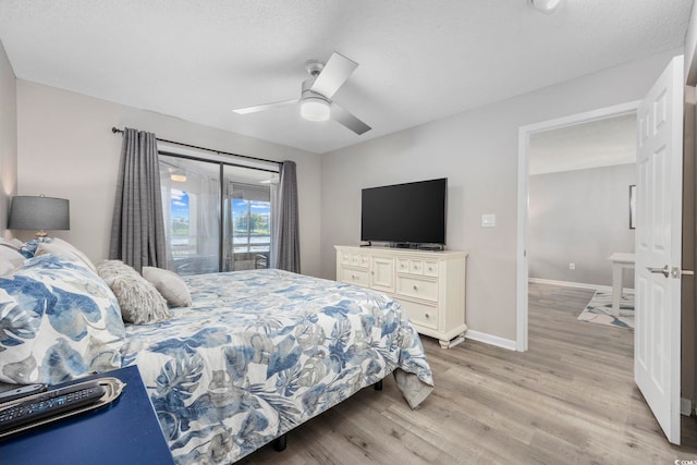 bedroom with light wood-style floors, baseboards, and ceiling fan