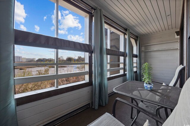 sunroom / solarium with a water view