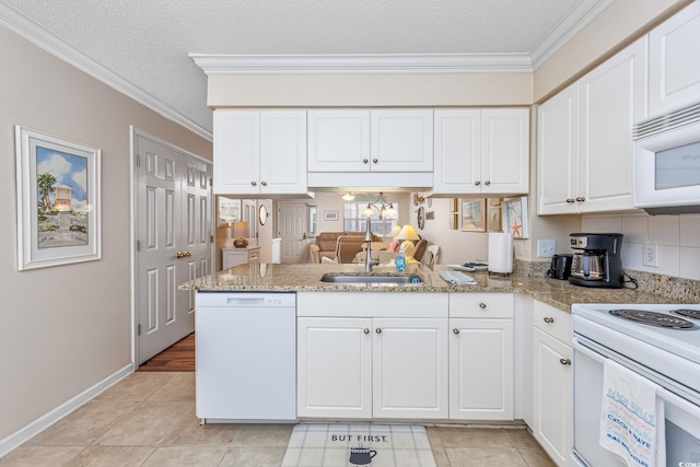 kitchen featuring crown molding, a peninsula, white appliances, white cabinetry, and a sink