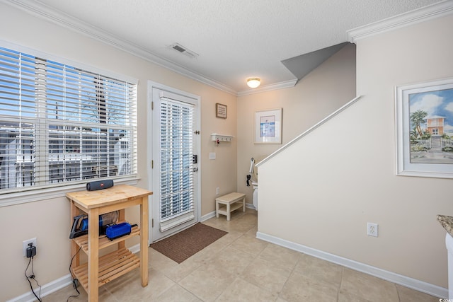 entryway with visible vents, a textured ceiling, crown molding, and baseboards