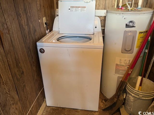 laundry room with electric water heater, washer / clothes dryer, laundry area, and wooden walls