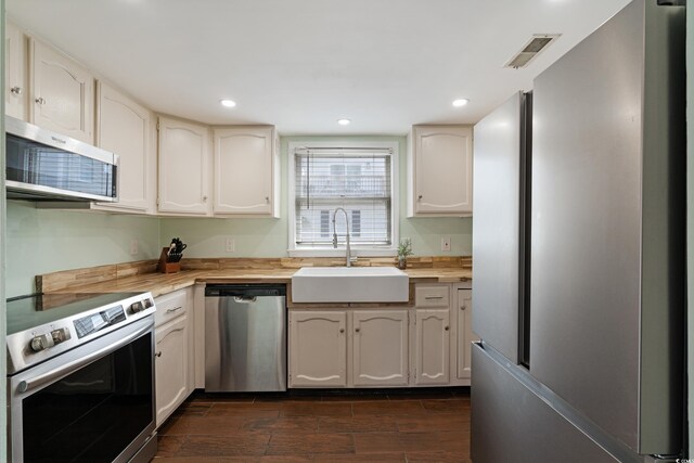 508-B Rosemary Ln, North Myrtle Beach, SC 29582 - kitchen featuring stainless steel appliances, a sink, wood finish floors, recessed lighting, and wood counters