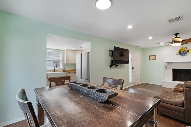 508-B Rosemary Ln, North Myrtle Beach, SC 29582 - dining space featuring dark wood-type flooring, a ceiling fan, baseboards, recessed lighting, and a brick fireplace