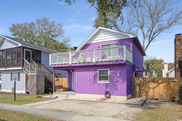 508-B Rosemary Ln, North Myrtle Beach, SC 29582 - view of front of home featuring stairs, a sunroom, a wooden deck, and a chimney